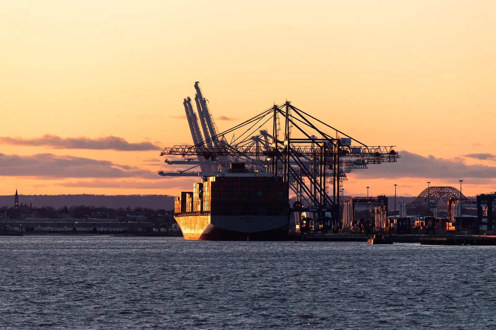 Container cranes and ship at dusk