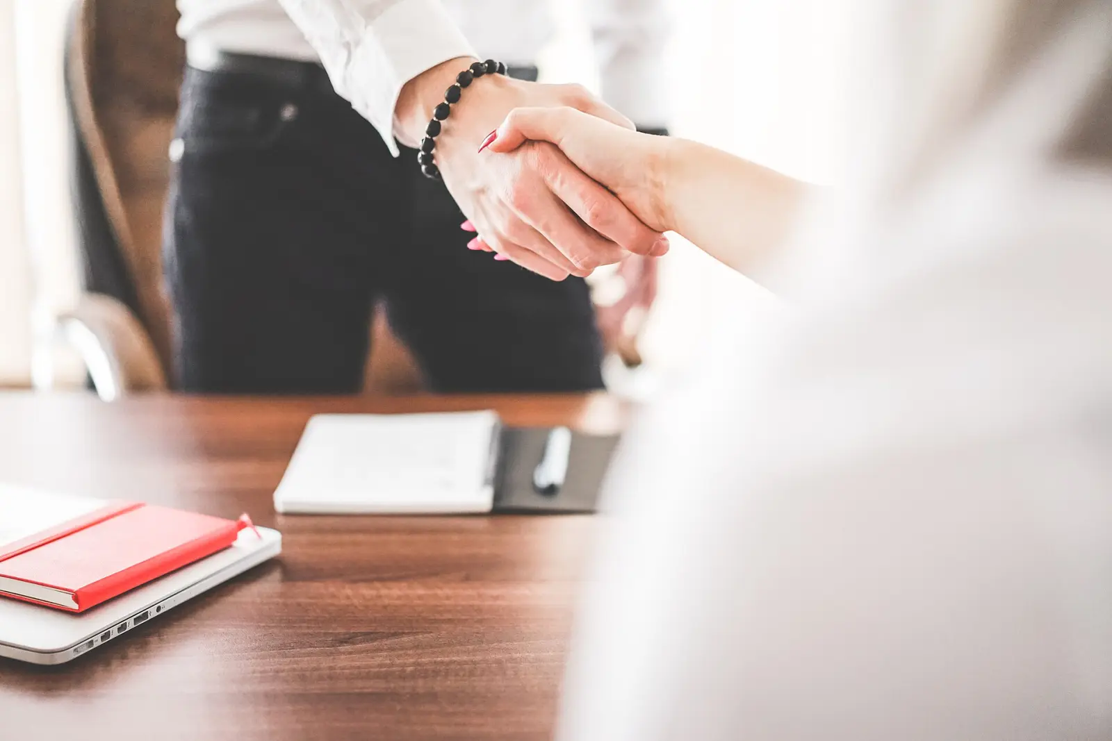 Handshake over an office desk