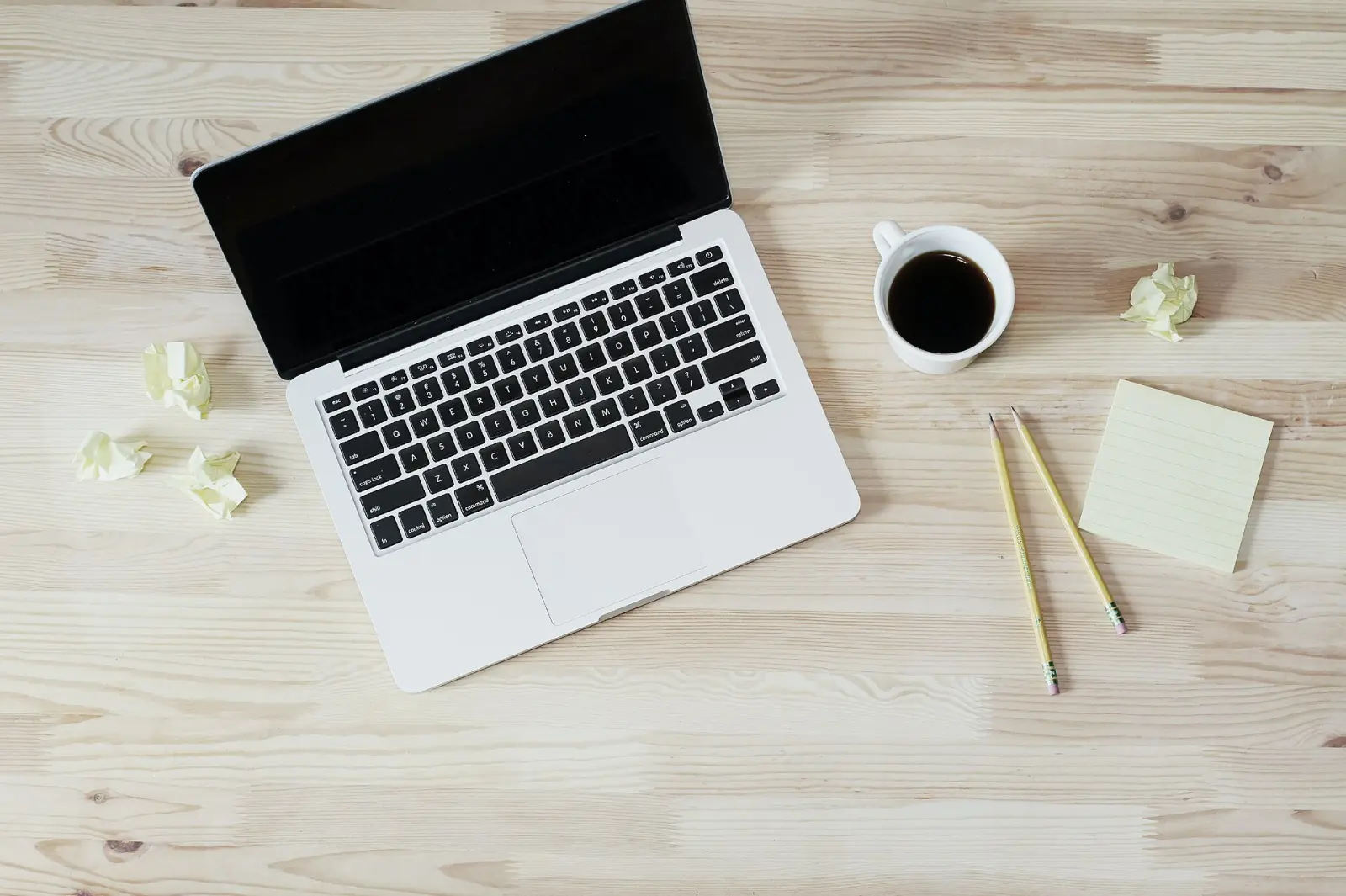 Laptop and coffee on a wooden desk